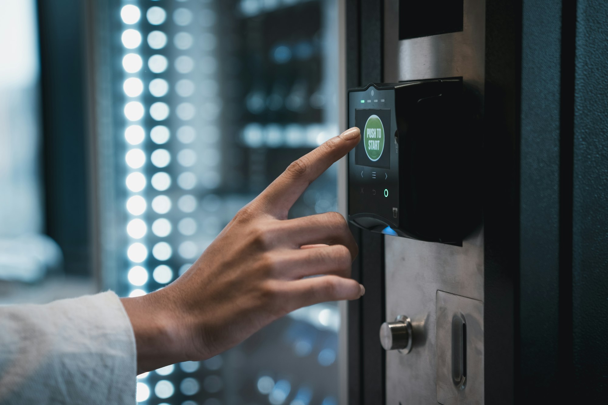 Close up hand of woman pushing button on vending machine for choosing a snack or drink.